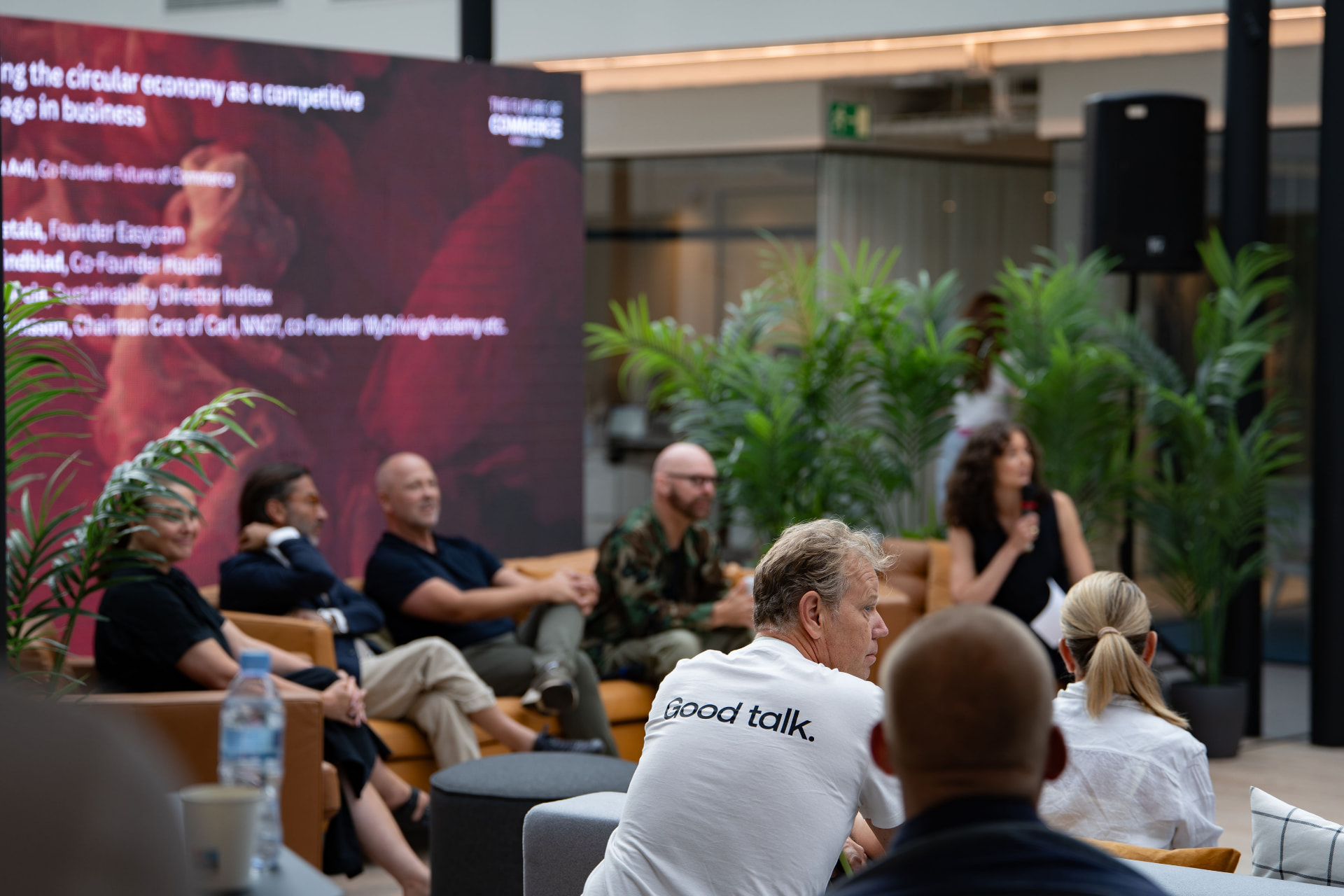 Speakers in conversation on stage